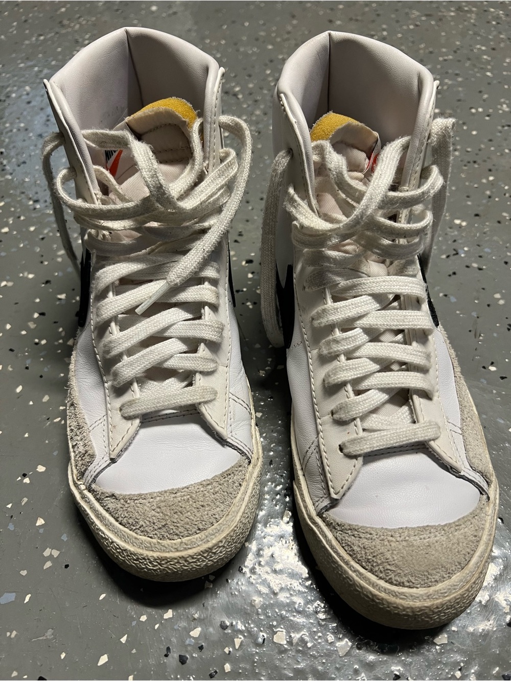 Nike White High-Top Sneakers with Black Swoosh and Yellow Tongue